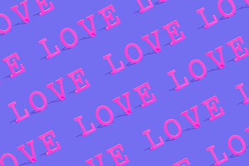 Creative pattern background with colorful Word LOVE. Love or Valentine's Day concept. Flat lay. Vivid pink and purple colors.