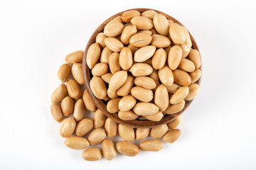 Bowl full of roasted peeled peanuts on white background
