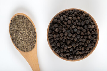 Ground black pepper with grains of black pepper on a white background,top view