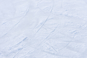 ice texture close up. Skating rink covered with snow. Skate tracks in the snow