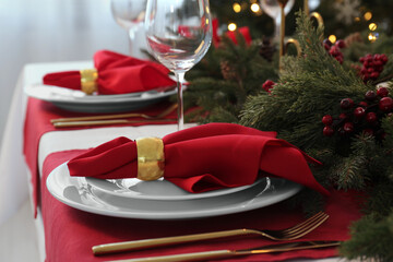Beautiful festive table setting with Christmas decor indoors