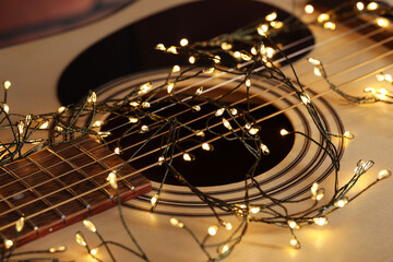 Closeup view of guitar with fairy lights