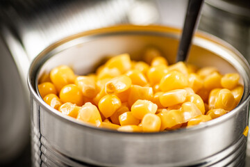 An open can of canned corn. 