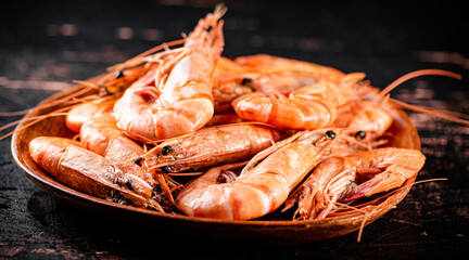 Boiled shrimp in a wooden plate. 