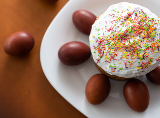 Easter cake and colored eggs. Traditional Easter baking. Easter holiday. Close-up.