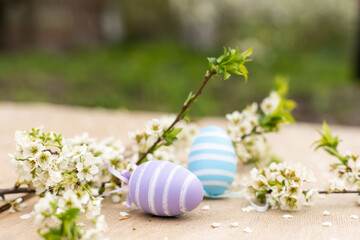 Colorful Easter eggs with spring blossom flowers. Colored Egg Holiday border.