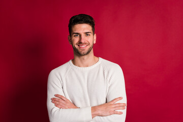 Positive young man with crossed arms