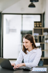 Asian businesswoman working in the office with working notepad, tablet and laptop documents .