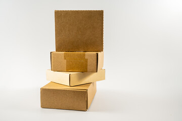 stack of new cardboard  mailling storage boxes ready for recycling into new products isolated on white background