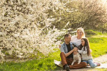 Happy family with dog in the garden.