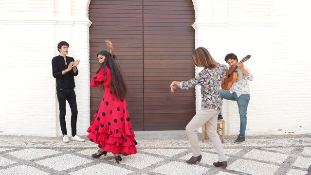 Multiethnic group of flamenco dancers dancing for tourists in San Nicolas. Albaicin.