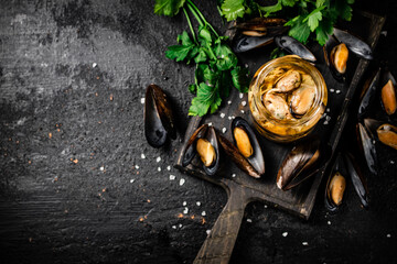 Delicious pickled mussels with parsley on the table. 