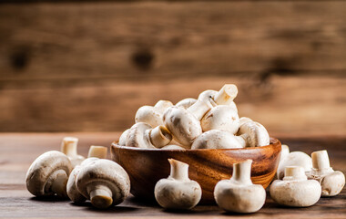 A wooden plate full of fresh mushrooms. 