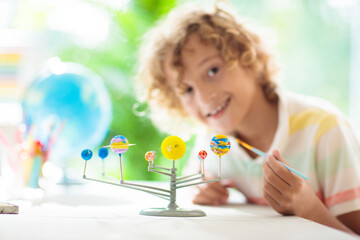 Child with solar system model. Kids planetarium. - obrazy, fototapety, plakaty