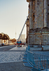 Fototapeta na wymiar Cleaner worker using a cherry picker to clean the windows of the Reichstag building in Berlin, Germany