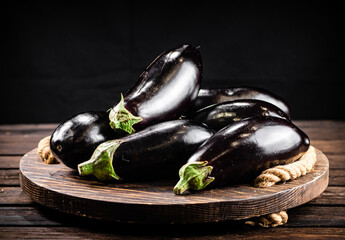 Ripe eggplant on a wooden tray. 