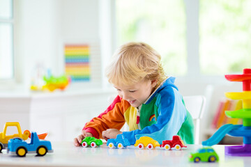 Fototapeta premium Boy playing toy cars. Kid with toys. Child and car