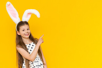 Portrait of a beautiful girl with big ears of an Easter bunny on her head, the onset of the Easter holiday.