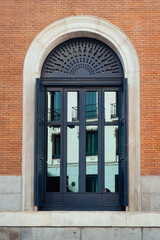Classic door with arch in brick facade of luxury building. Exterior viewe