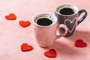 Two coffee cups with heart in pink and black colors for Valentines Day