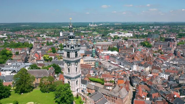 Aerial summer skyline panorama of the old town of Mons (Bergen). The Belfry of Mons (Beffroi de Mons) in the foreground. Wallonia, capital of Hainaut, Belgium. 