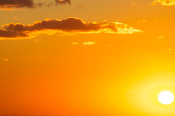 Sunset or sunrise with a few clouds and sun