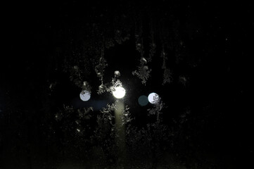 light in the night window during the rain