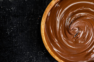 Hazelnut butter in a wooden plate. 