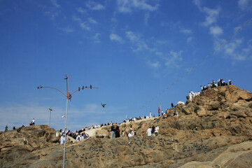 Pilgrims praying and visiting the Mount Arafat Jabal al-Rahmah in Hejaz, Saudi Arabia.