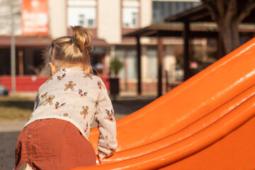 Little girl plaing at playground - obrazy, fototapety, plakaty