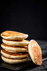 Ready made homemade pancakes on a stone board. 