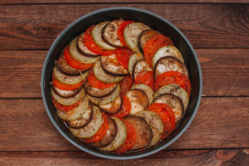 Ratatouille dish of eggplant, zucchini and tomatoes. Top view