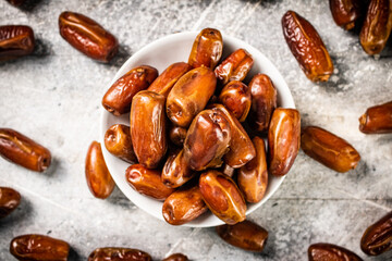Full bowl with dates on the table. 