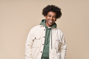 Happy young African American gen z guy isolated on beige background. Smiling hipster ethnic teen student, cool curly ethnic generation z teenager fashion model standing looking at camera, portrait. - obrazy, fototapety, plakaty