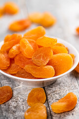 Fragrant dried apricots in a bowl on the table. 