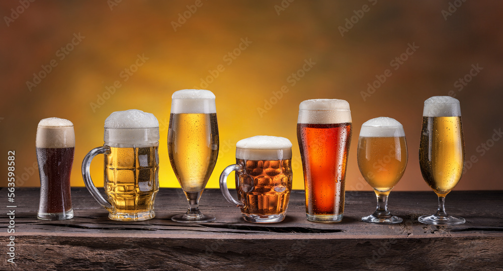 Sticker collection of different beer glasses and beer types on old wooden table.