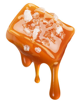 Salty caramel candy and drops of milk caramel sauce flowing down from it. File contains clipping path.