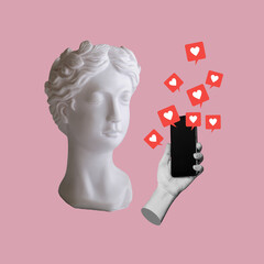 Antique statue's head with hand holding mobile phone with like symbols from social networks on pink...