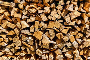 Photography on theme big wall of stacked oak tree logs in cracks