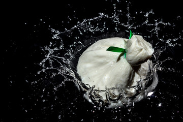 Burrata cheese when falling into the water with splashes