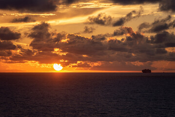 Dramatic sunset sky over the calm ocean. 