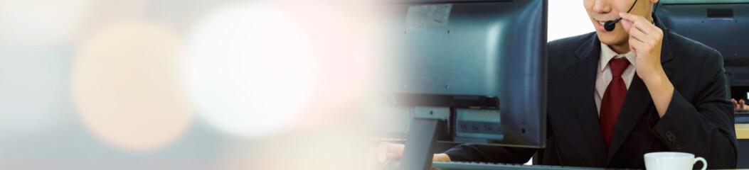 Business people wearing headset working in office in widen view to support remote customer or...