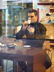 Man Drinking Coffee from Outside of the Bar Window