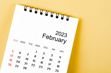 A February 2023 Monthly desk calendar for 2023 year on yellow background.