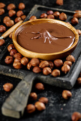 Hazelnut butter on a cutting board with a spoon. 