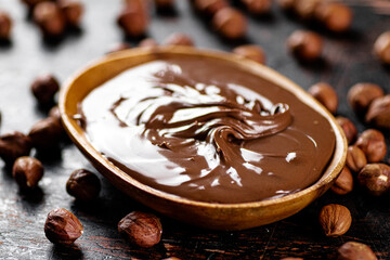 Hazelnut butter with peeled hazelnuts on the table. 