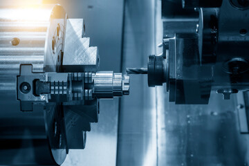 The multi-tasking CNC lathe machine  milling cut the metal shaft parts by milling turret. © Pixel_B
