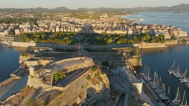 Aerial morning shot of Kerkyra, capital of Corfu island, Greece. Flying over buildings, park and sea in Kerkyra, Corfu island
