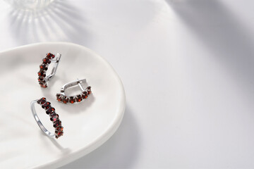 Elegant jewelry set. Jewellery set with gemstones. Jewelry accessories collage. Product still life concept. Ring, necklace and earrings.