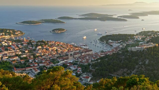 Aerial view of Hvar city, Croatia. Hvar island during sunset. Panoramic shot of the island city and Yachts sailing the Adriatic sea. UHD